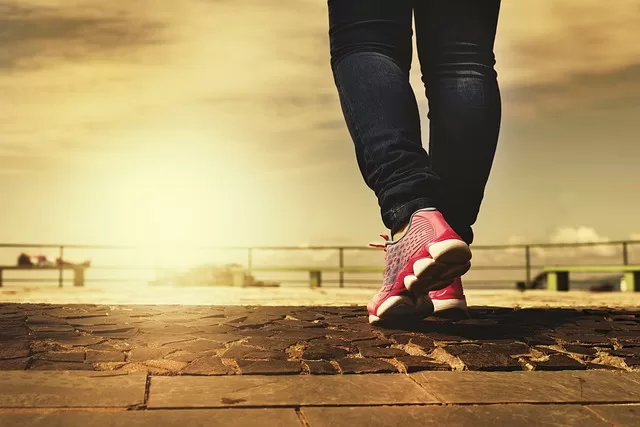 Woman with running shoes representing september physical health goals