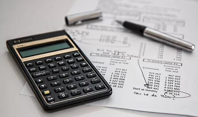 calculator and pen representing financial goals