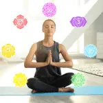 in this picture a lady do a meditation and the seven chakras rotating around