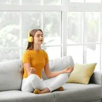 In this image lady listen a music during a meditation for concentration