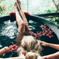 In this image lady relax in the bath tub